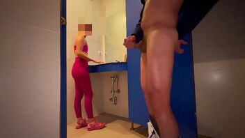 A woman catches me masturbating in the gym locker room and helps me to climax.