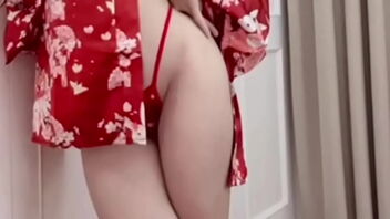 Pretty Asian woman exposes her buttocks in a dress