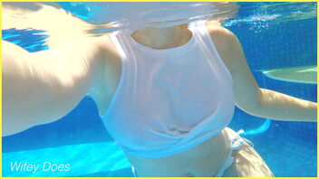 Public swimming pool scene with a mature lady in a milky wet shirt.