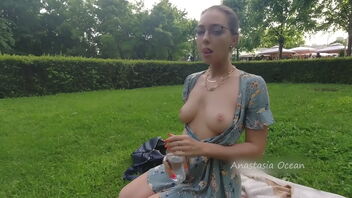 Beautiful woman showing her great all-natural tits in the park