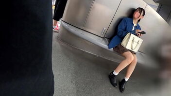 A young woman with dark-hued hair walks around Shibuya and shows off her beautiful legs.