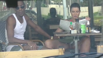 A cheating wife caught on camera while flirting with a black man in a cafe.