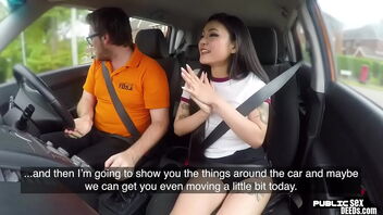 An Asian hotty gets her pussy gobbled by a driving tutor while giving blow job in a car