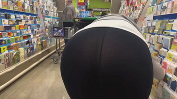 A Walmart shop assistant in a rather tight dress exposes her charms.